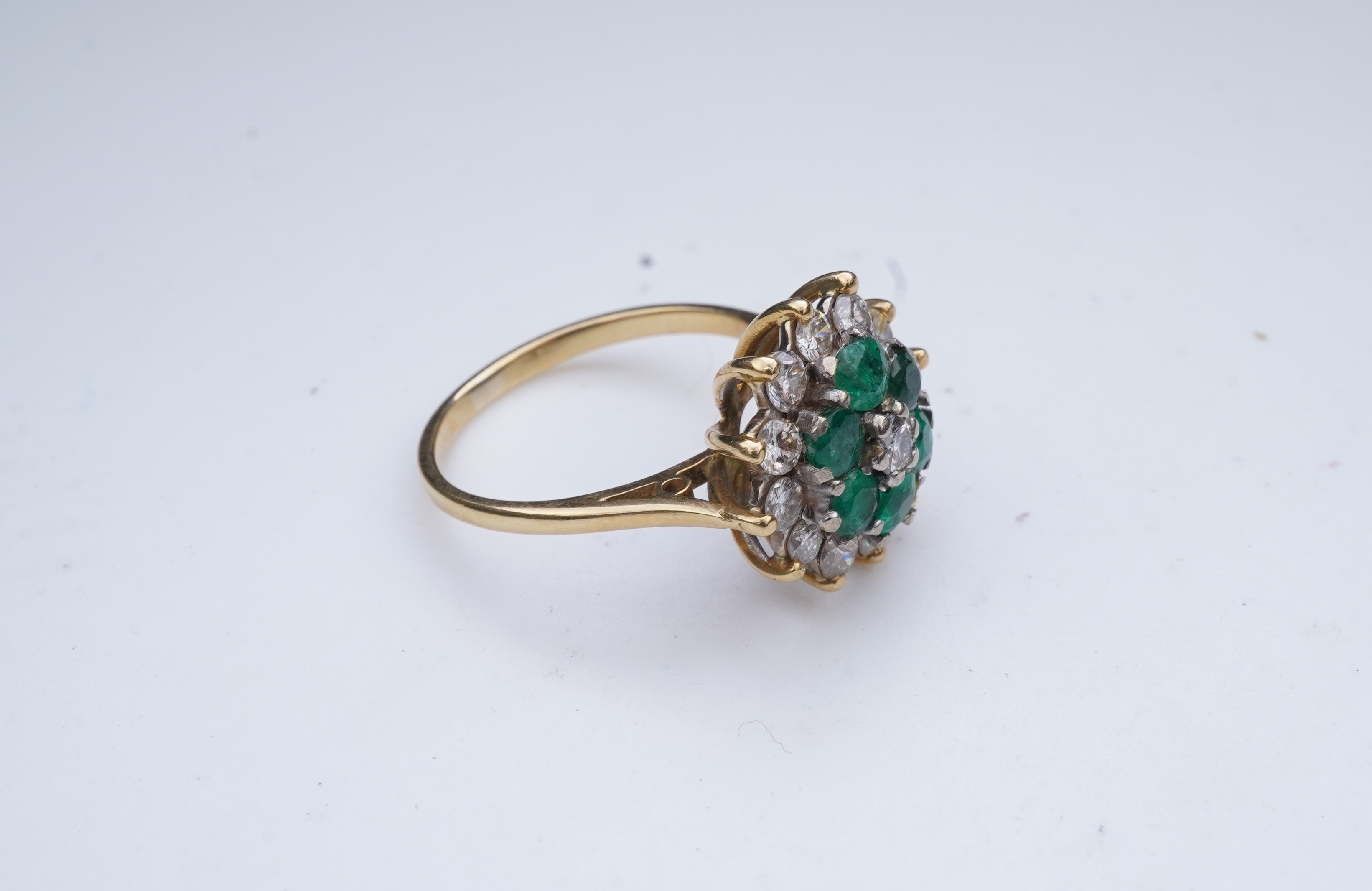 An emerald and diamond ring